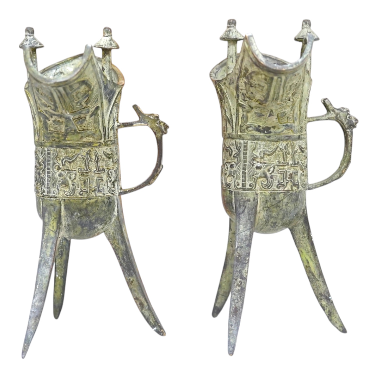 A pair of Chinese archaistic bronze vessels on tripod legs, jue, 20.5cm high. Condition - fair.